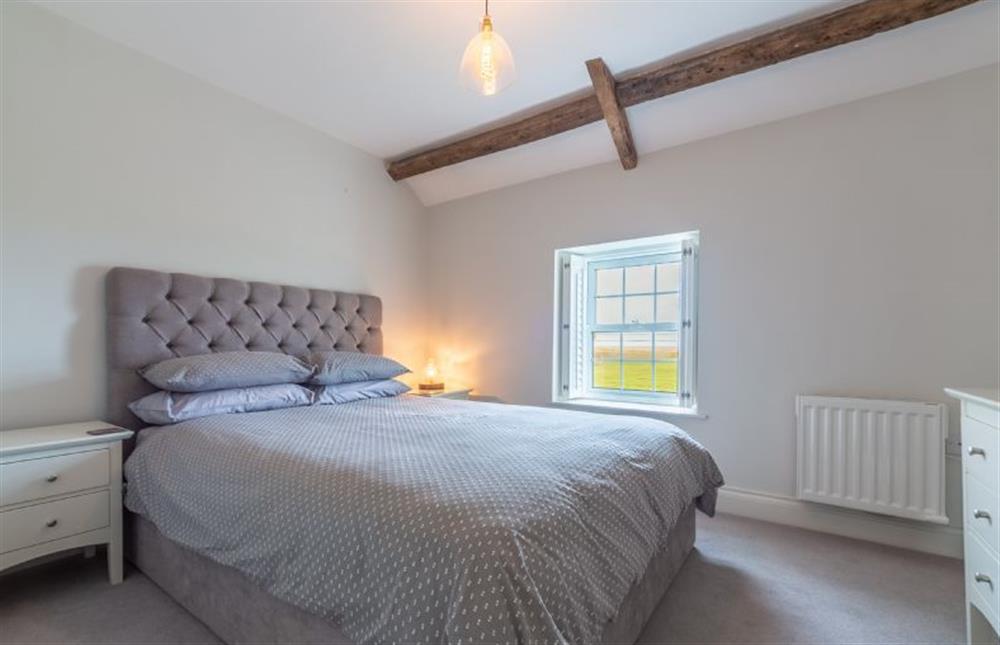 First floor: Bedroom three with king-size bed and views across the mashes    at Barn Cottage, Salthouse near Holt