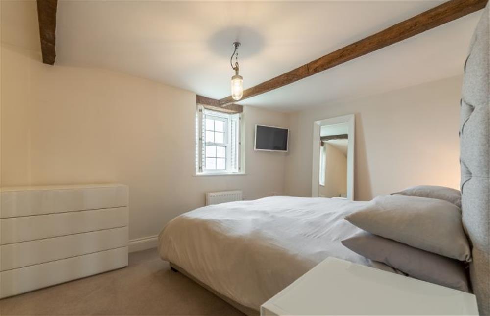 First floor: Master bedroom with views across the marshes at Barn Cottage, Salthouse near Holt