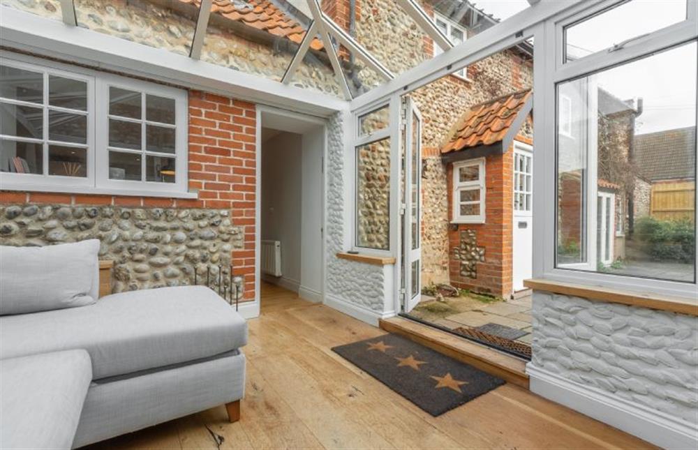 Ground floor: Conservatory with door back in to kitchen and doors to garden at Barn Cottage, Salthouse near Holt
