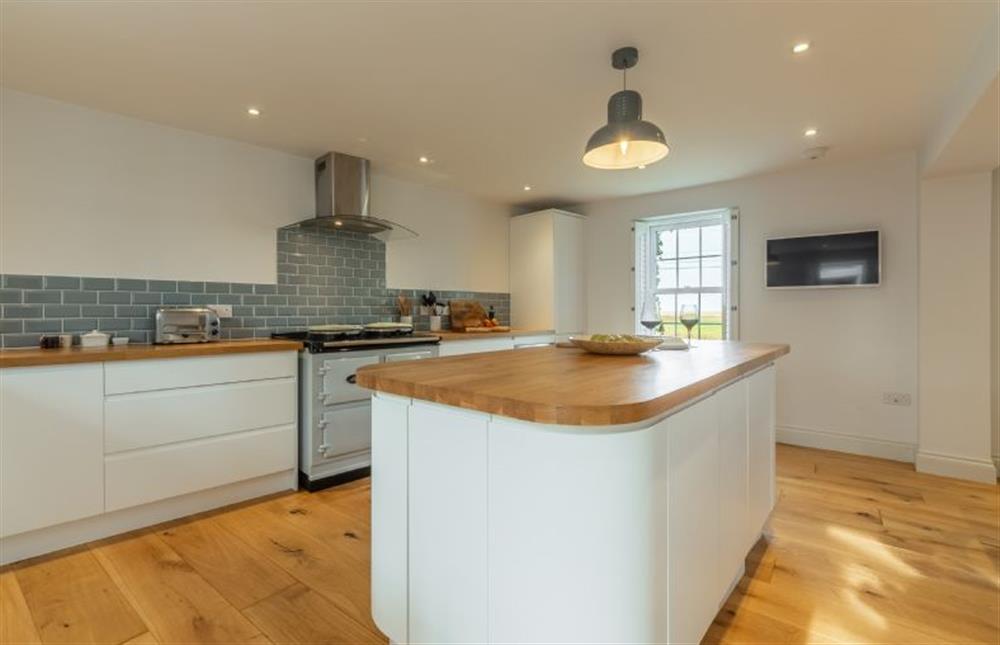 Ground floor: Kitchen with window overlooking the marshes to the sea at Barn Cottage, Salthouse near Holt