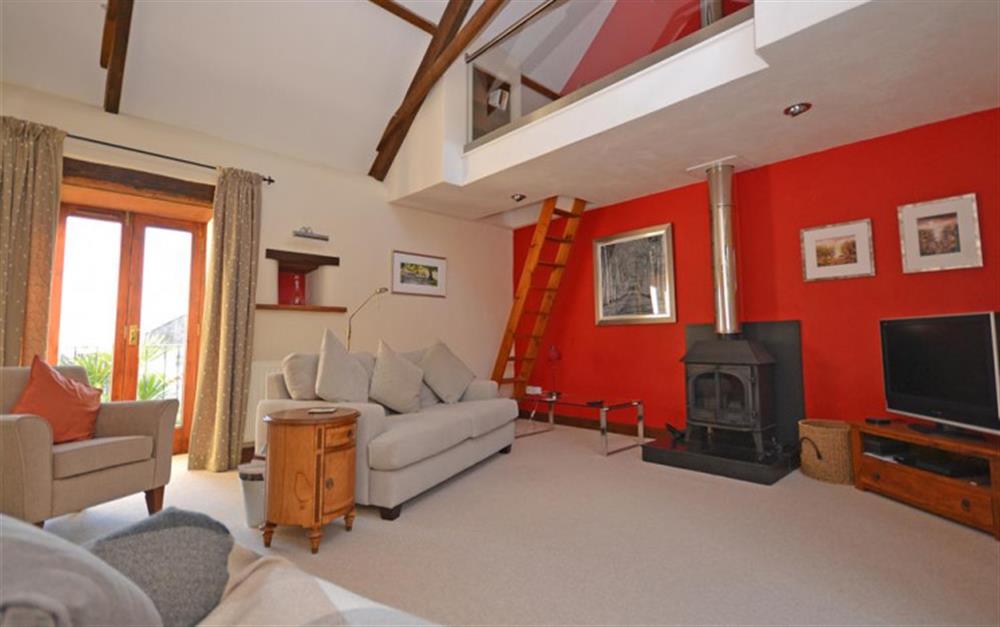 The attractive lounge, with juliet balcony and mezzanine snug at Barn Dipperty in Loddiswell