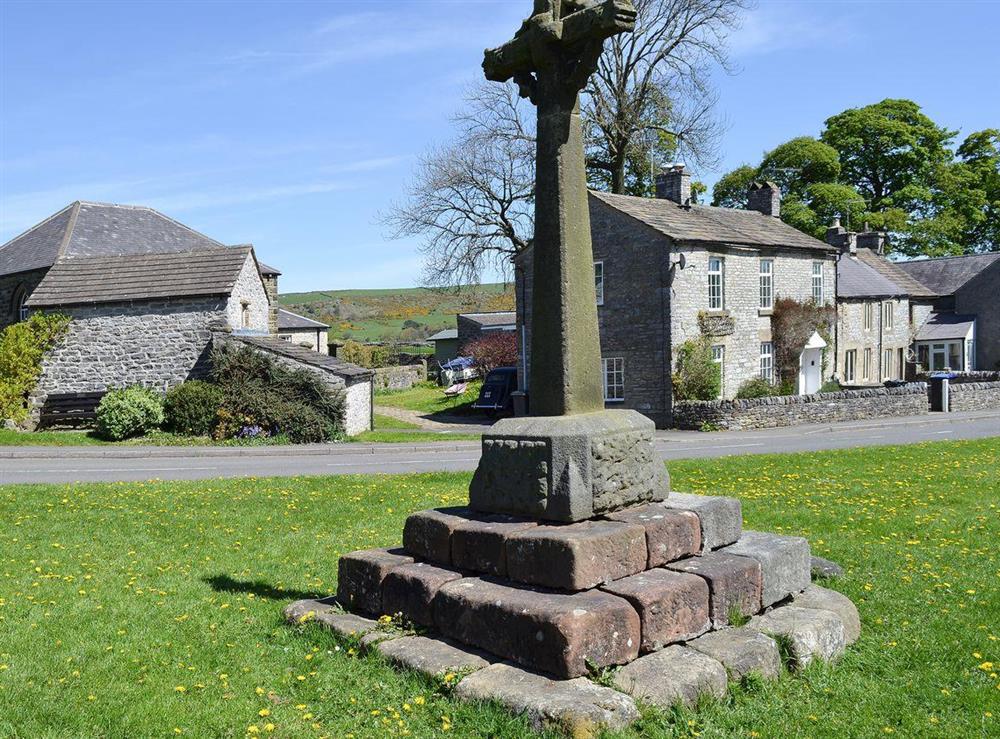 Village memorial Cross at Barn on the Green in Foolow, near Tideswell, Derbyshire, England