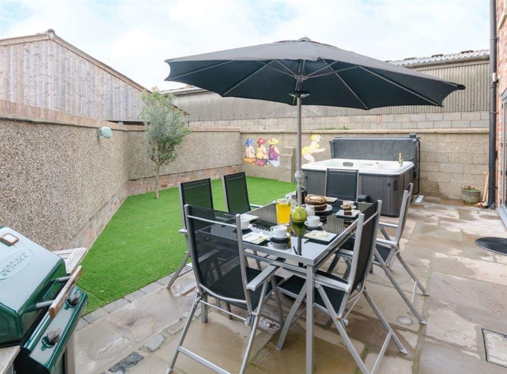 Large garden with hot tub and dining area at Barn Owl Cottage in Skidby, near Beverley, North Humberside
