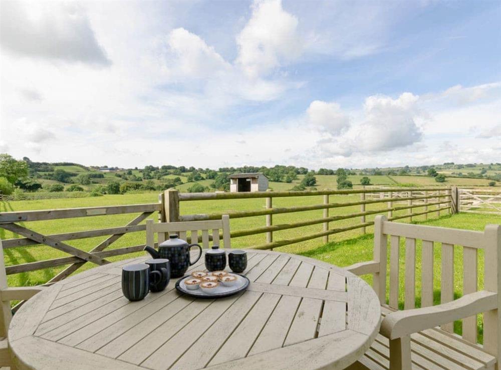 Outdoor dining area with stunning countryside views at Barn Owl Lodge in near Carsington, Derbyshire