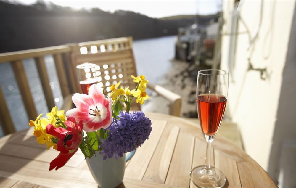 A drink on the decked balcony at Barnacles, Fowey