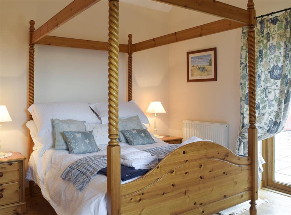 Four poster bedroom at Barns End Cottage in Ludchurch, near Amroth, Pembrokeshire, Dyfed