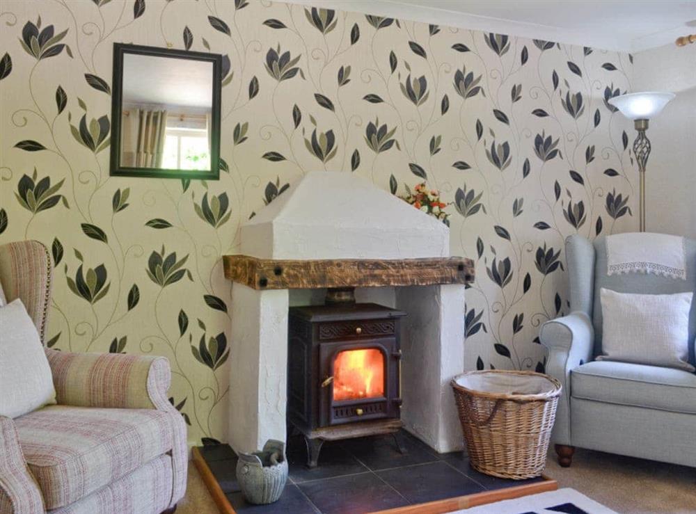 Attractive living room with wood-burner at Baron Cliff Lodge in Cove, near Helensburgh, Dumbartonshire