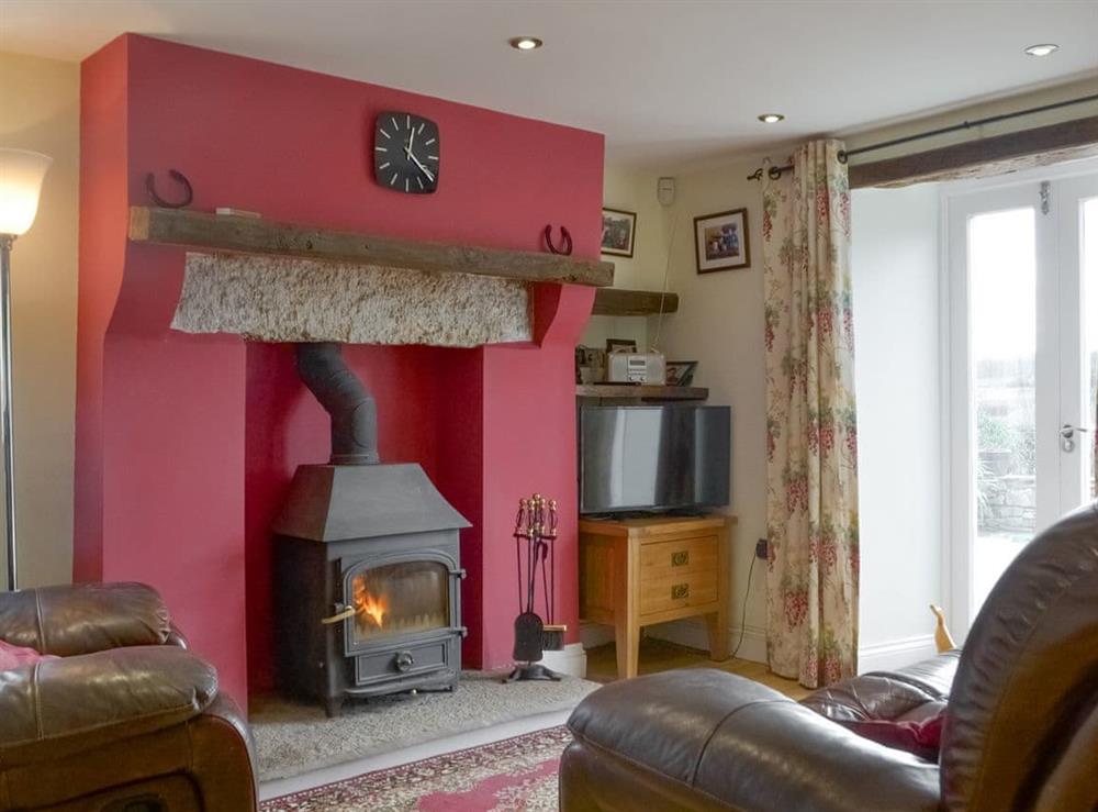 Inviting living area with wood burner at Barrow Tenement in Lyth Valley, near Kendal, Cumbria