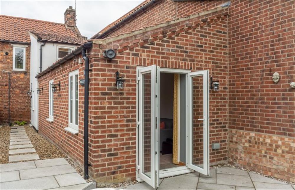 French doors from the sitting room to the patio  at Basil Cottage, Wells-next-the-Sea