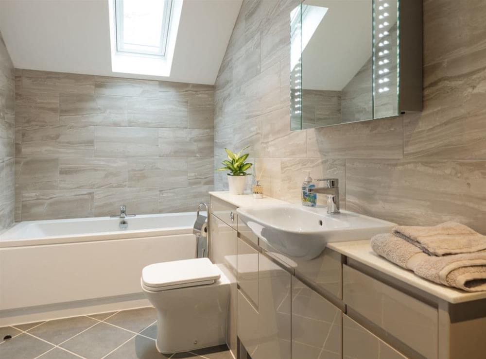 En-suite bathroom with bath, walk-in shower, toilet and heated towel rail at Bay Cottage in Boughton, near Downham Market, Norfolk