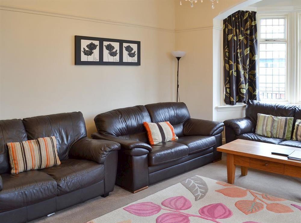 Living room with comfortable leather sofas at Bay House in Filey, North Yorkshire