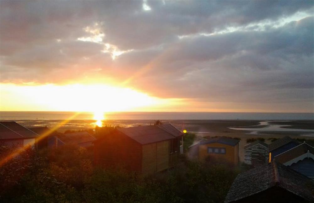Sunset over the beach huts at Bay View Apartment, Hunstanton