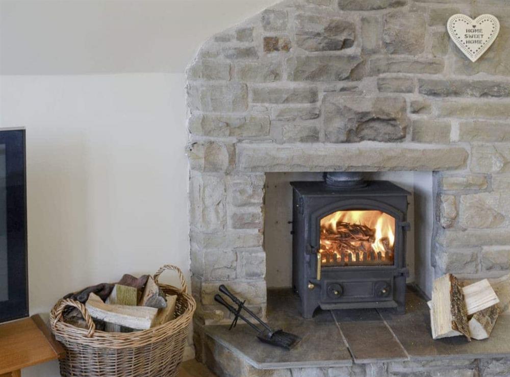 Warming wood burner in living and dining room at Bay View in Hunmanby Gap, near Filey, North Yorkshire