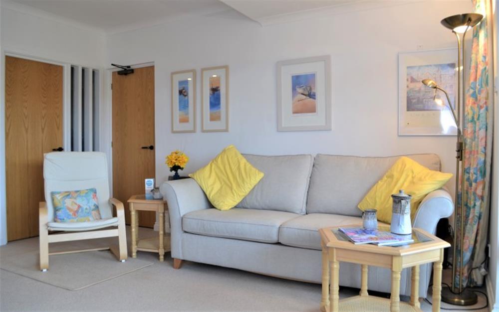 The lovely light and airy lounge area showing the large sofa and an occasional chair. at Bay View in Maenporth