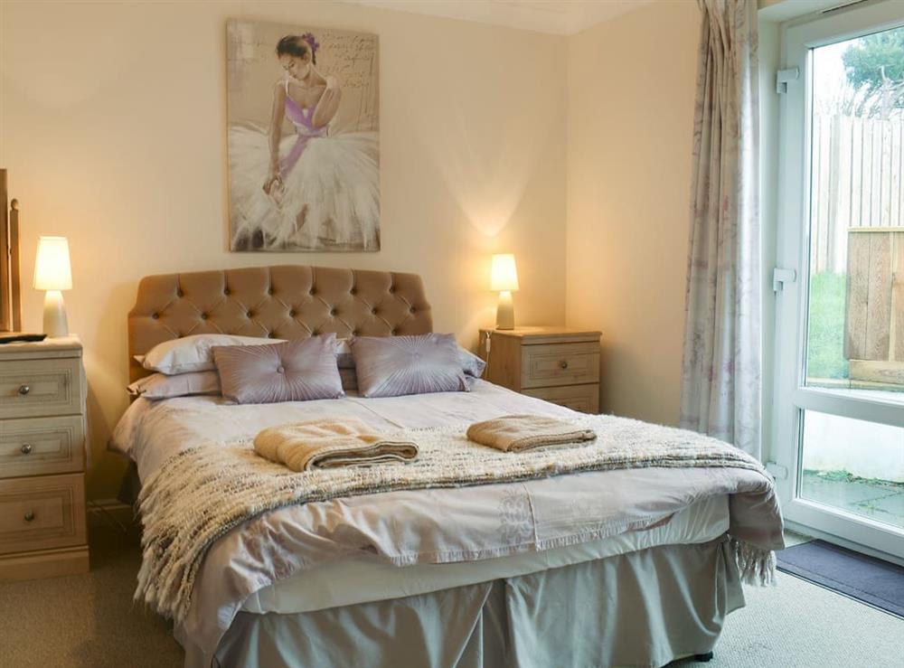 Comfortable bedroom with double bed and single bed at Bay View West Wing in Carlyon Bay, near St Austell, Cornwall