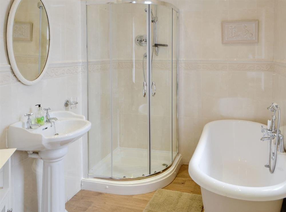 Family bathroom with roll-top bath and separate shower cubicle at Bay View in Whitley Bay, Tyne and Wear