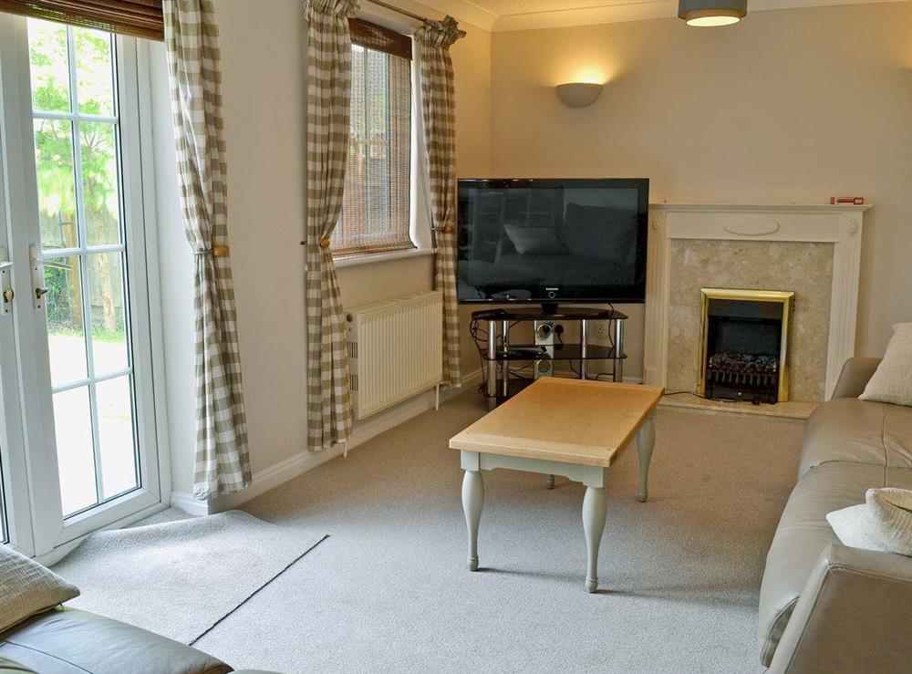 Spacious Living room/dining room with French doors at Baytree House in Wimborne, Dorset