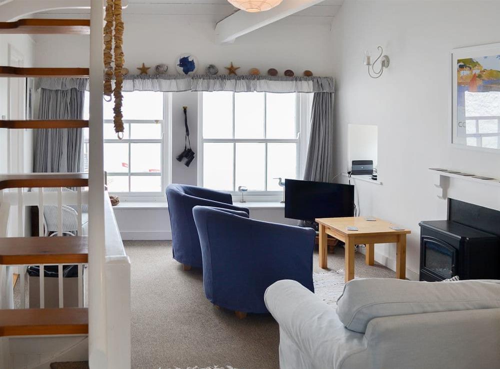 Charming living area with paddle staircase to second floor at Beach Corner Cottage in Gorran Haven, near St Austell, Cornwall
