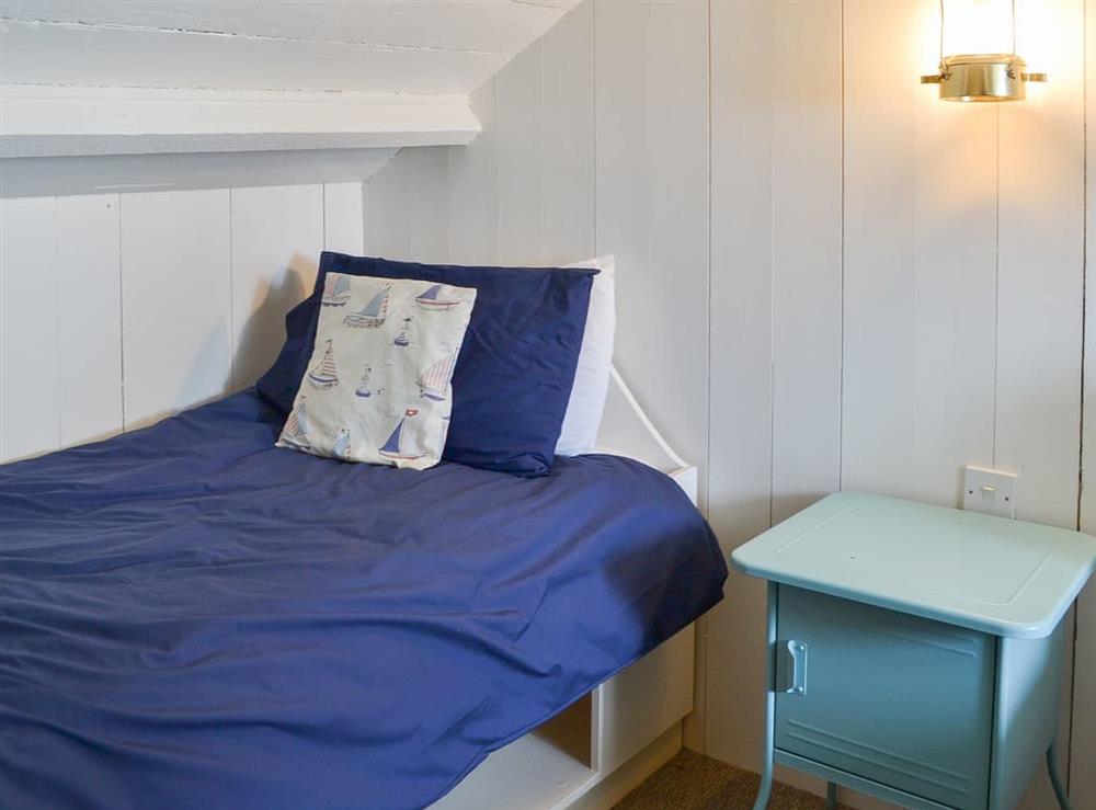 Twin bedroom with sloping ceilings at Beach Corner Cottage in Gorran Haven, near St Austell, Cornwall