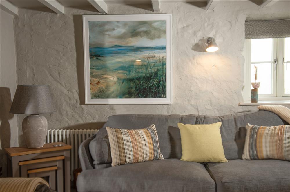 Beach Cottage: Sitting room with local artwork at Beach Cottage and The Lobster Pot, St Agnes