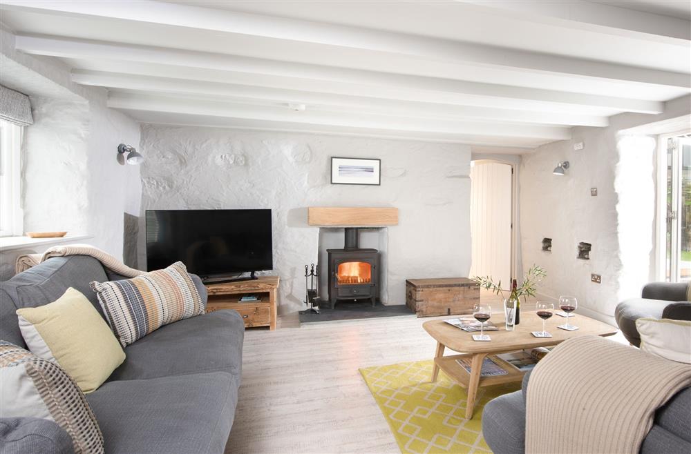 Beach Cottage: Spacious sitting room with a wood burning stove (photo 2) at Beach Cottage and The Lobster Pot, St Agnes