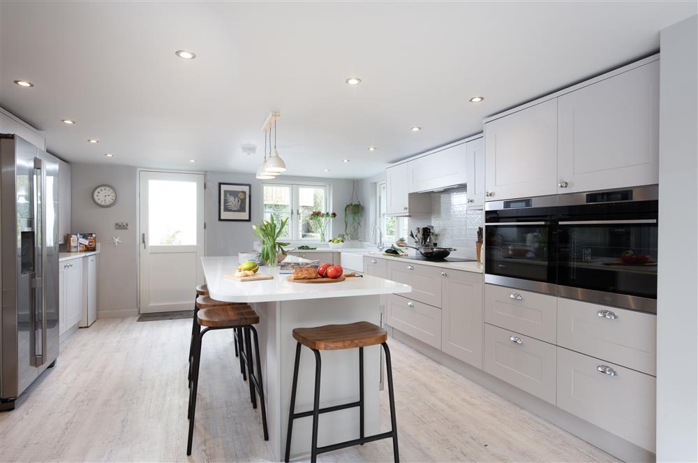 Beach Cottage, Cornwall: Fully-fitted kitchen with breakfast bar seating  at Beach Cottage, St Agnes