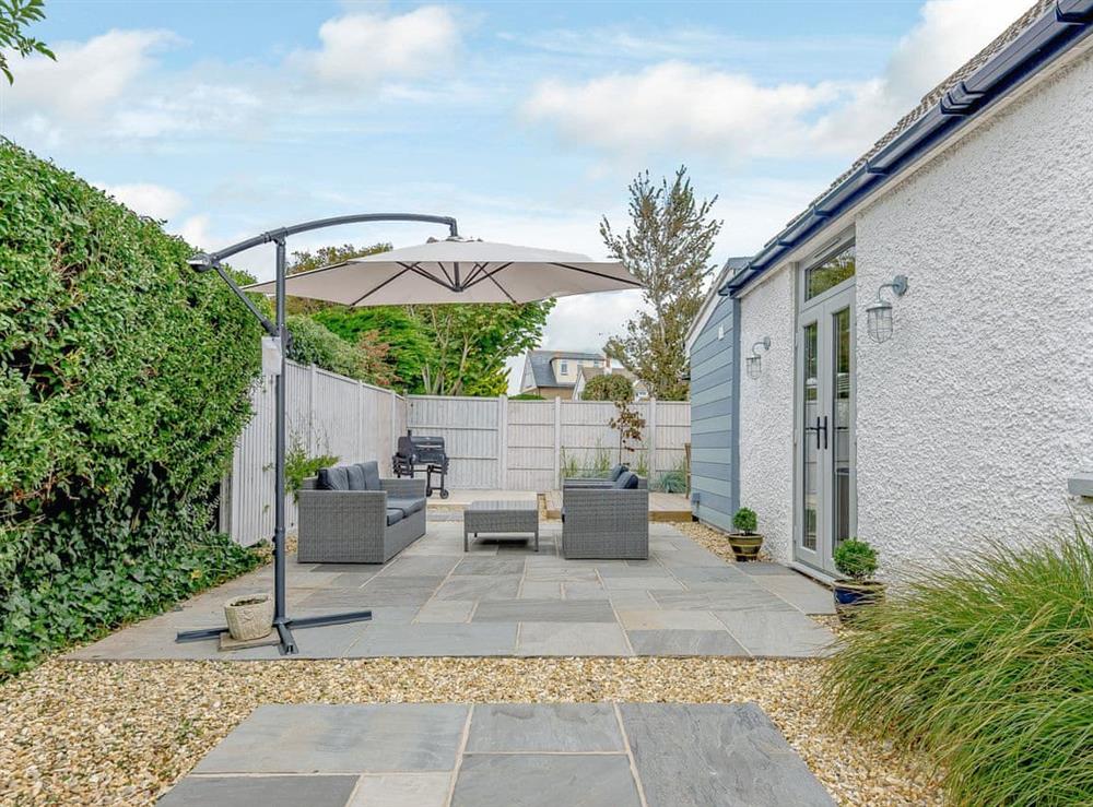 Private decked patio and outside dining area (photo 2) at Beach Holme in East Wittering, West Sussex