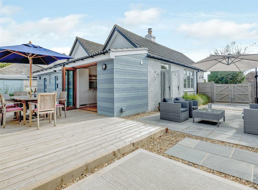 Private decked patio and outside dining area at Beach Holme in East Wittering, West Sussex