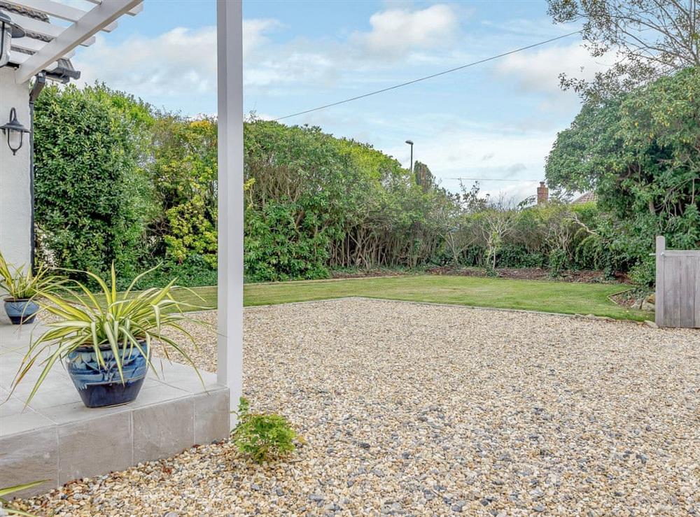 Private front garden area with lawn at Beach Holme in East Wittering, West Sussex