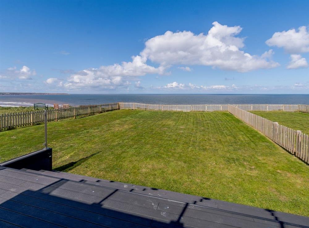 View to the sea over the garden at Beach House in Reighton Gap, near Filey, North Yorkshire