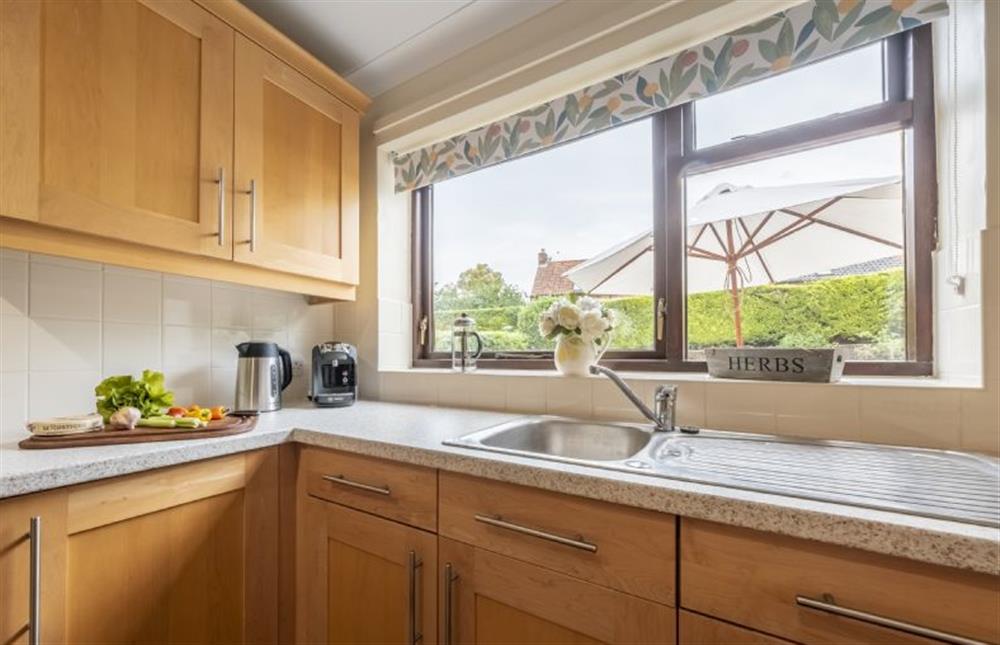Kitchen with window to enclosed rear garden at Beach Retreat, Brancaster near Kings Lynn