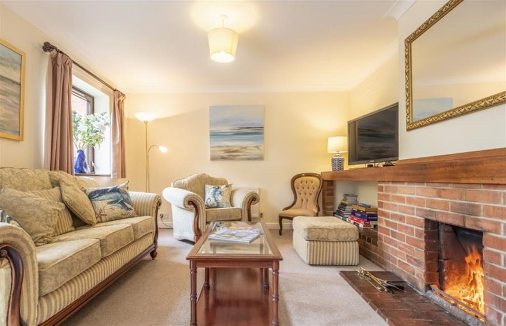 Traditional sitting room with open fire at Beach Retreat, Brancaster near Kings Lynn