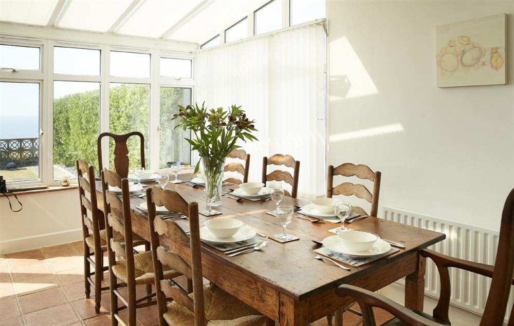 Dining table in the conservatory seating eight guests at Beach View, Southbourne