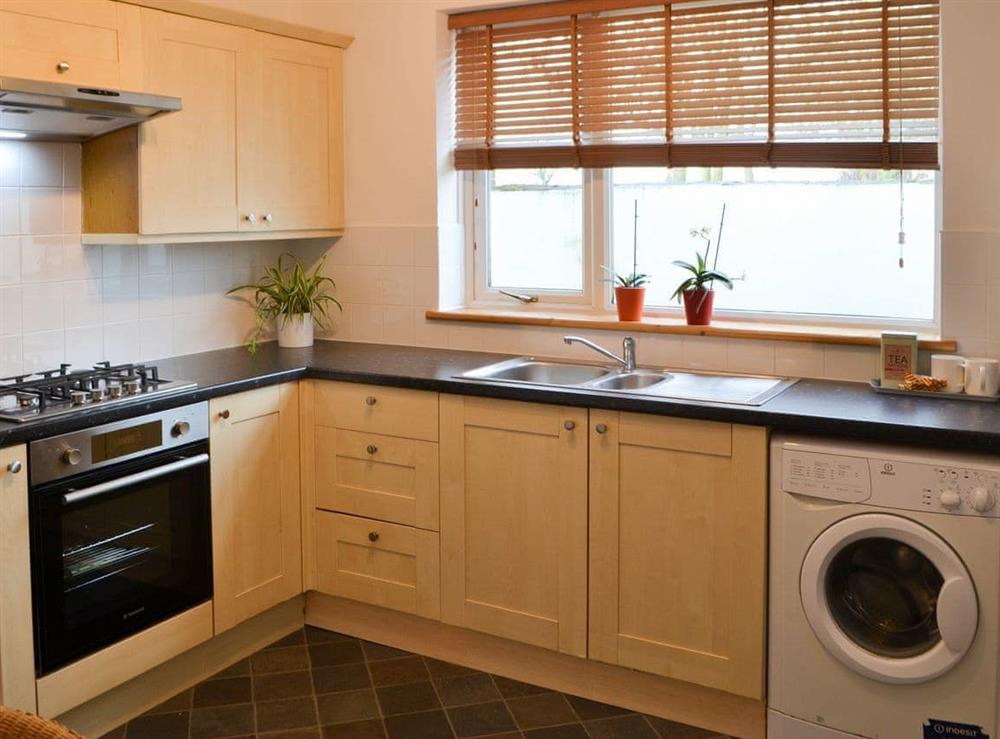 Well appointed kitchen with laundry facilities at Beachcomber Cottage in Newbiggin-by-the-Sea, near Ashington, Northumberland