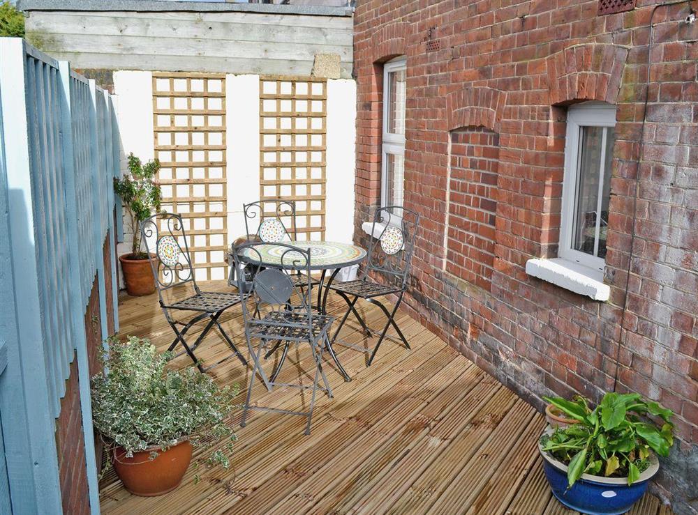 Enclosed courtyard garden, sitting-out area and furniture at Beachcomber in Cromer, Norfolk