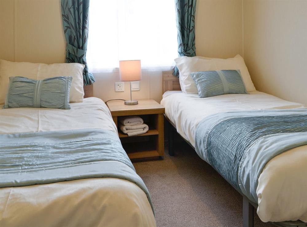 Comfortable bedroom with twin single beds at Beachcomber Lodge in Southerness, near Dalbeattie, Dumfriesshire