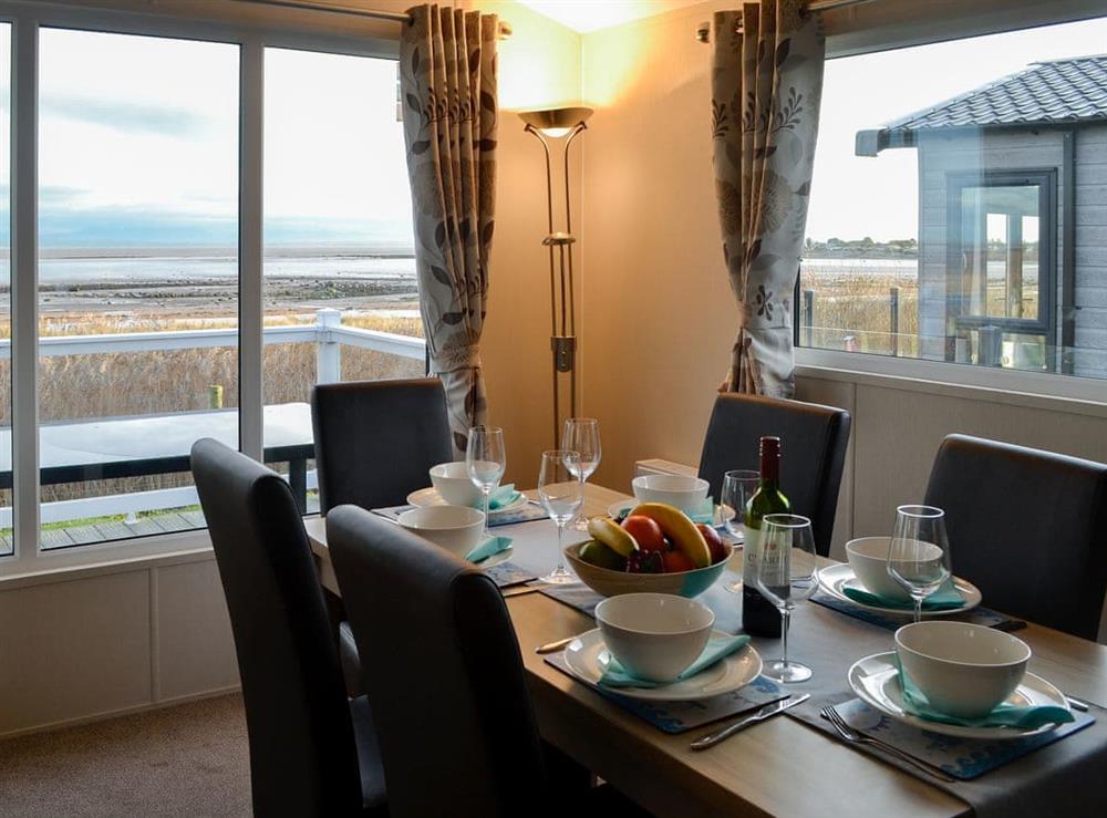 Dining area with dual aspect views at Beachcomber Lodge in Southerness, near Dalbeattie, Dumfriesshire