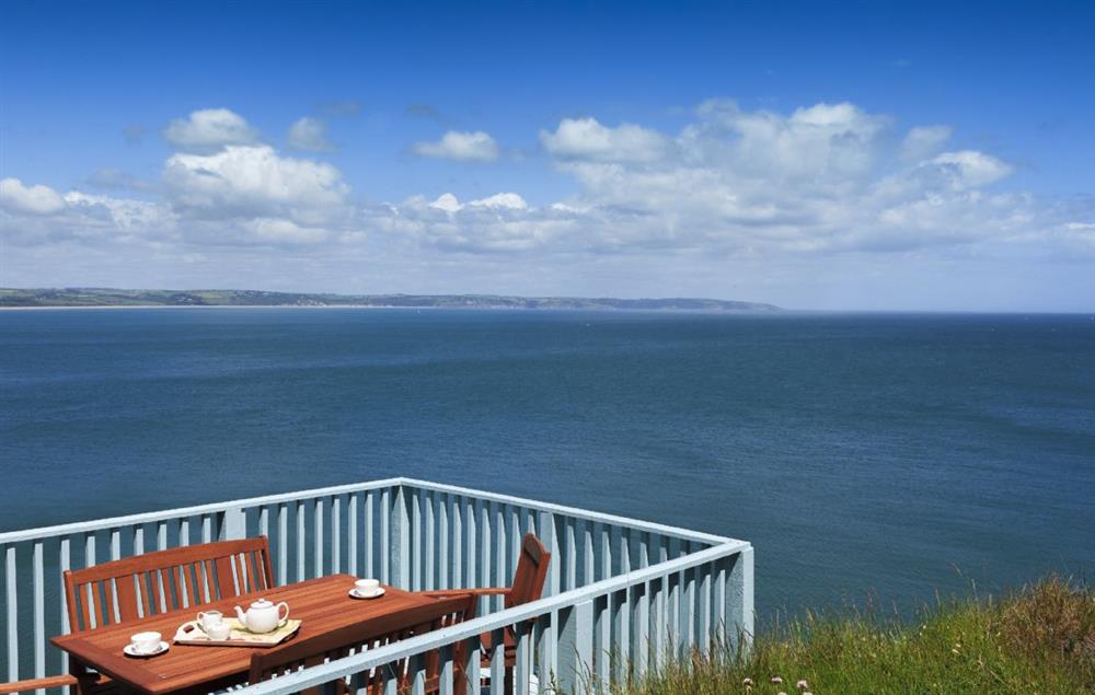 Decked patio area overlooking the cliffs and the sea at Beacon Cottage, Start Point Lighthouse