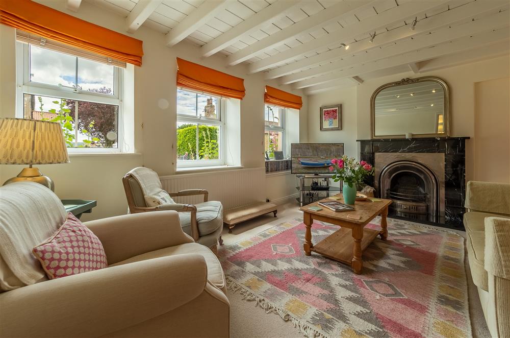 Ground floor: Sitting room featuring exposed beams and feature ornamental fireplace