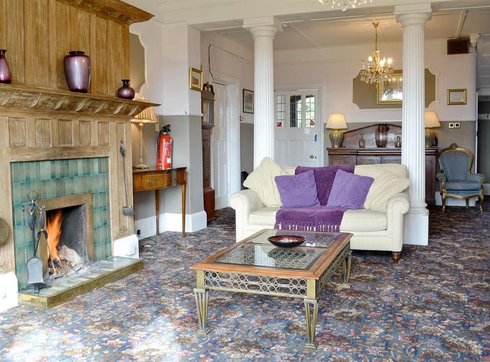 Spacious living room with plenty of character, and an open fire at Beaford House in Beaford, near Winkleigh, Devon