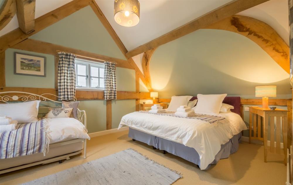 Double bedroom with 6’ zip and link bed at Bearwood Cottage, Pembridge