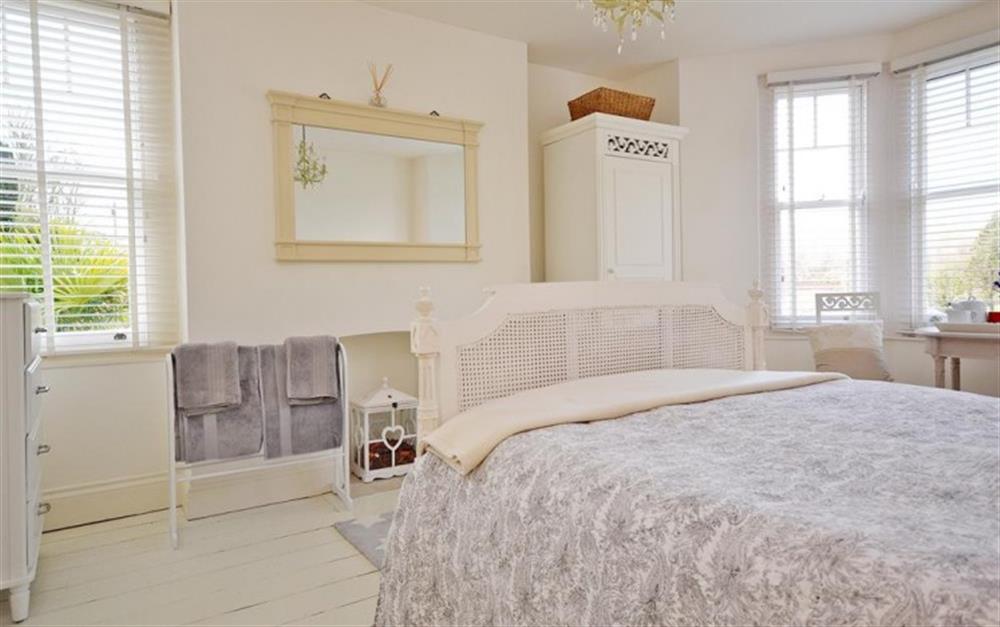 The charming master bedroom with wonderful views of the river. at Beau Rivage in Looe