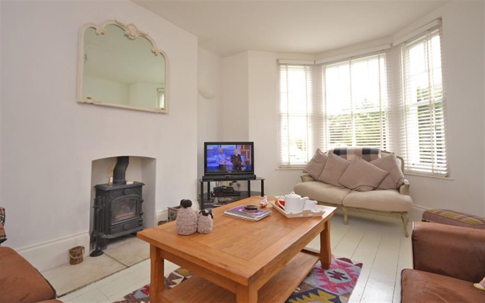 The comfortable and bright sitting room.  Wood Stove is not in use. at Beau Rivage in Looe