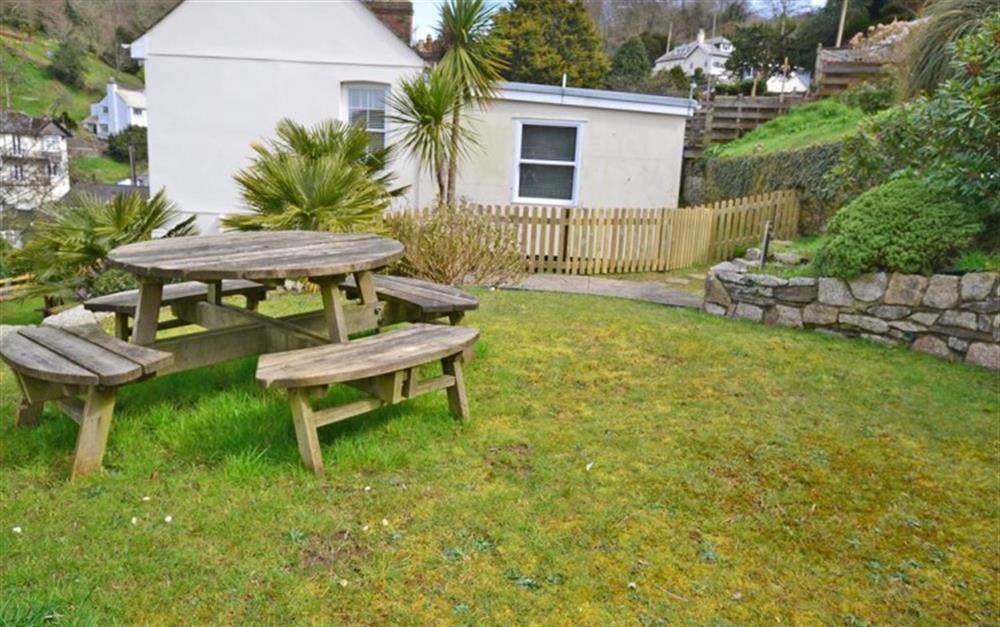 The upper lawned picnic table terrace at Beau Rivage in Looe