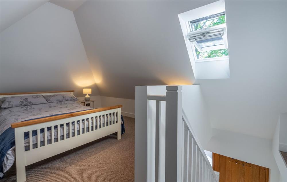 Spacious loft bedroom with double bed and veux window at Beau View Cottage, Bridge