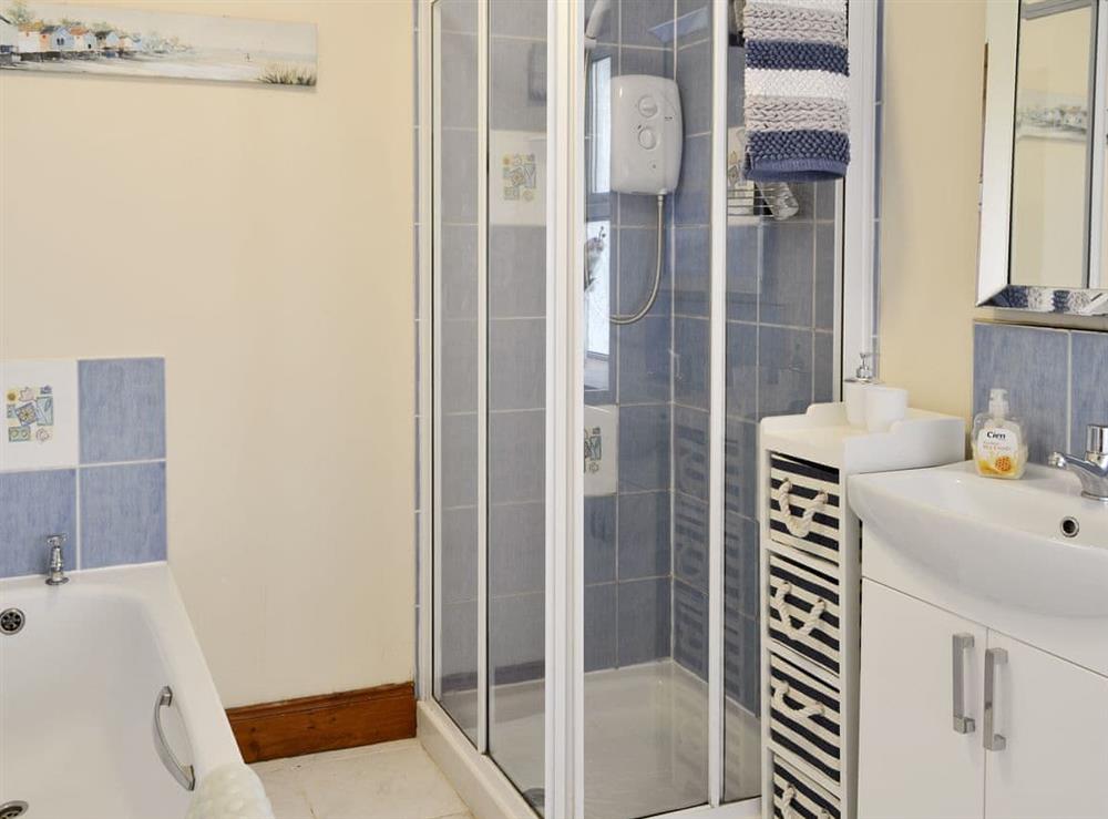 Family bathroom with bath and separate shower cubicle at Nursery Cottage, 