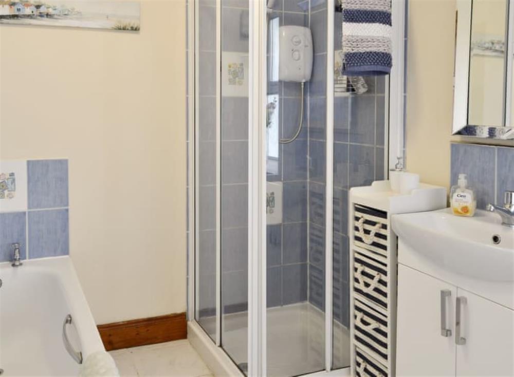 Family bathroom with bath and separate shower cubicle at Nursery Cottage, 