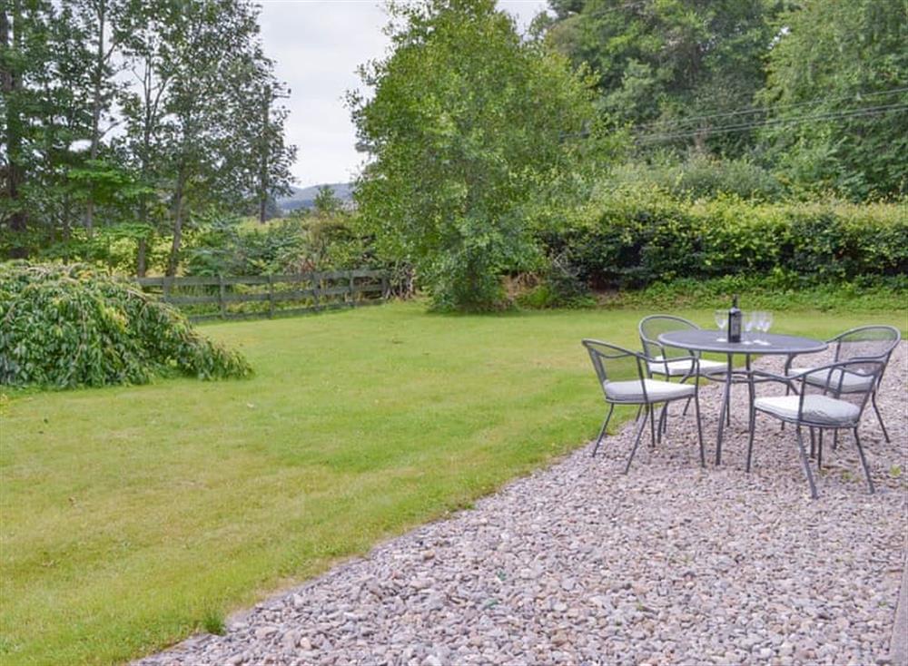 Gravelled patio area with outdoor furniture at Nursery Cottage, 