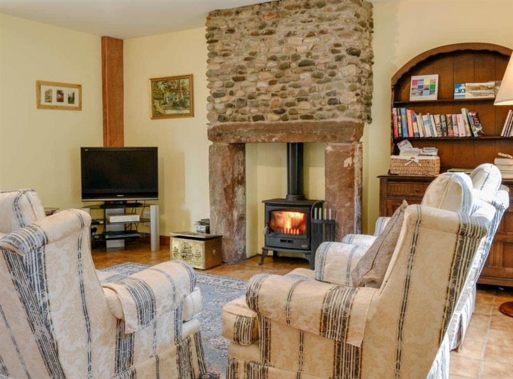 Charming living/ dining room with cosy wood burner at Beck Cottage in Croasdale, near Ennerdale Lake, Cumbria