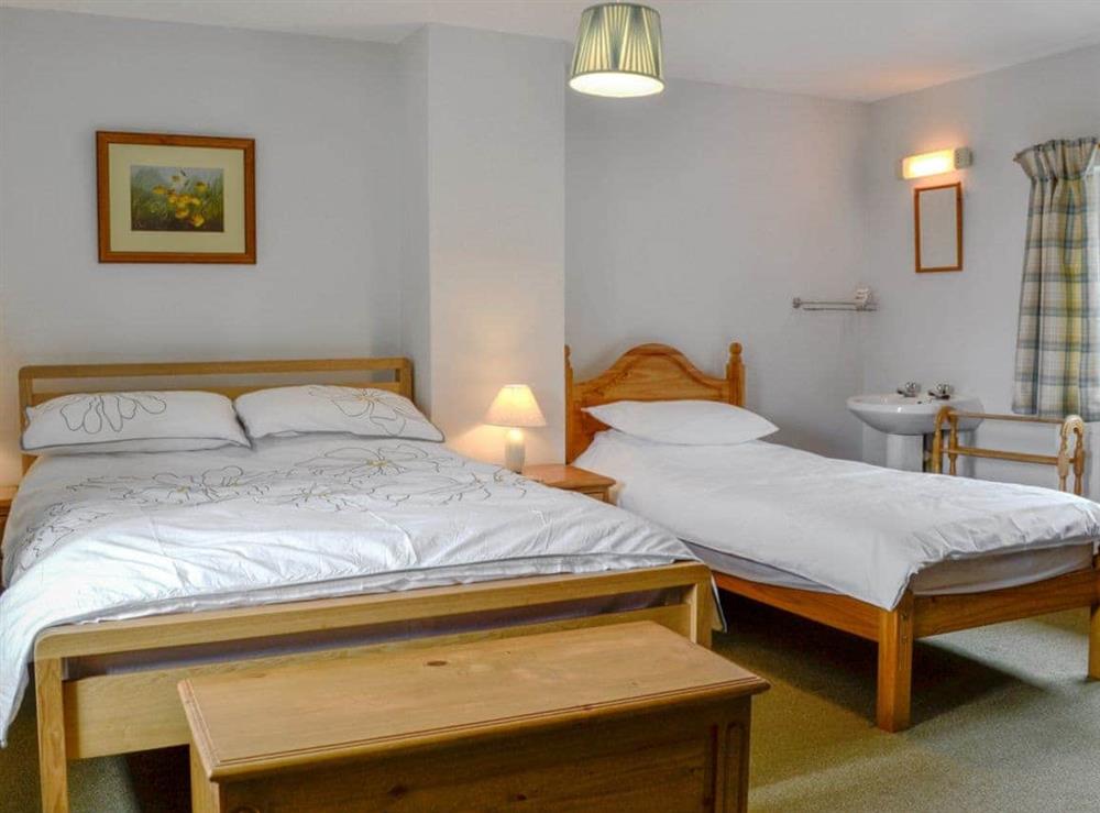 Comfortable double bedroom with an additional single bed at Beck Cottage in Croasdale, near Ennerdale Lake, Cumbria